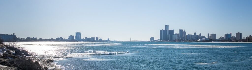 Detroit skyline seen across the icy Detroit River from Belle Isle, the Renaissance Center at right